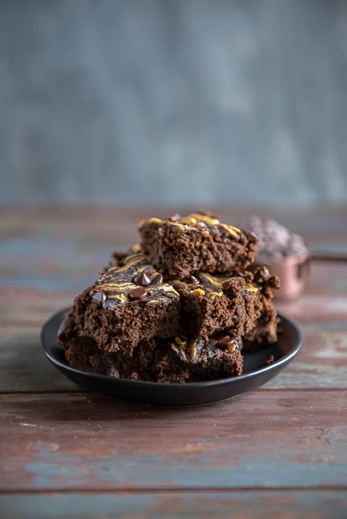 Black bean Brownies cut up on a plate and piled high.