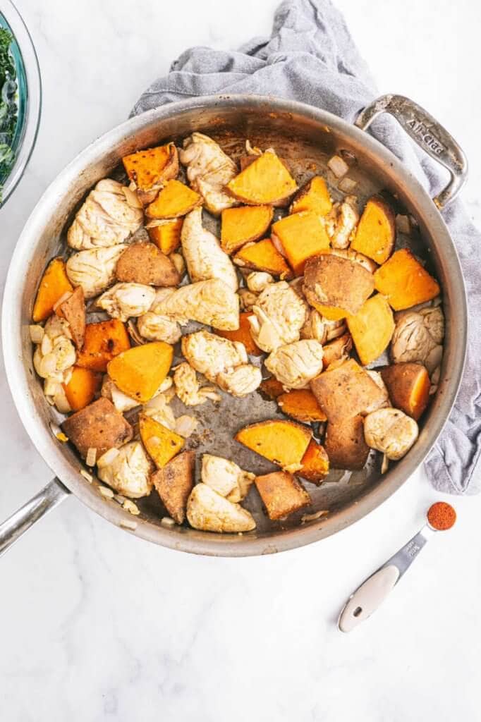 Skillet filled with chicken sweet potato and chipotle chili powder