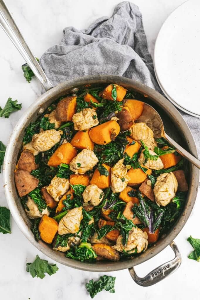Skillet filled with kale, sweet potato and chicken