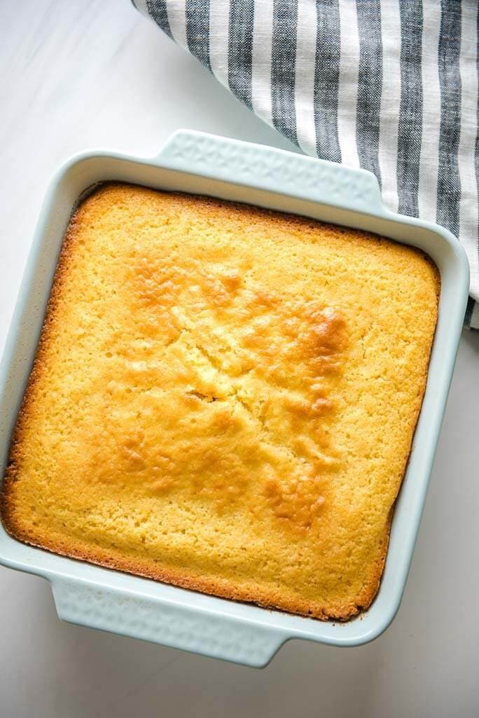 A pan of cornbread with a grey and white linen