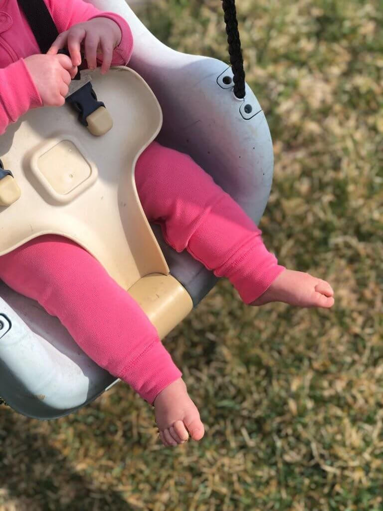 Baby in a swing and only showing her legs