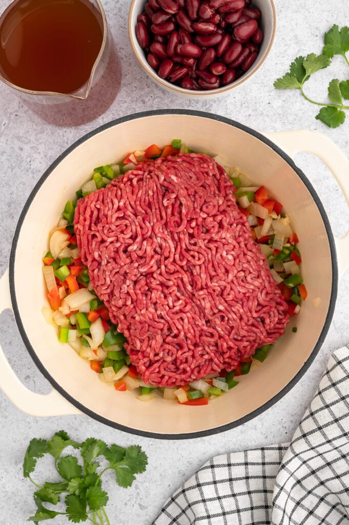 raw ground beef over sauteed vegetables