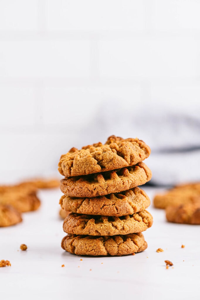 a stack of peanut butter cookies on a white background