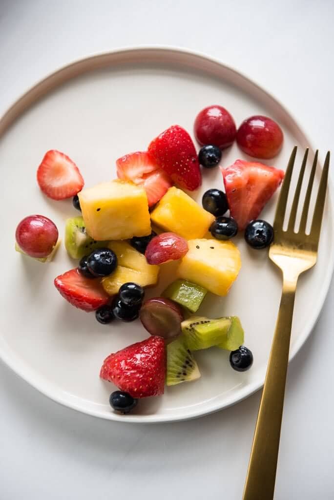 Mixed fruit salad on white plate