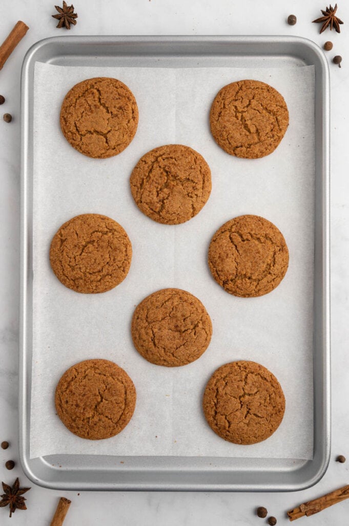 a cookie sheet with pumpkin spice cookies fresh out of the oven