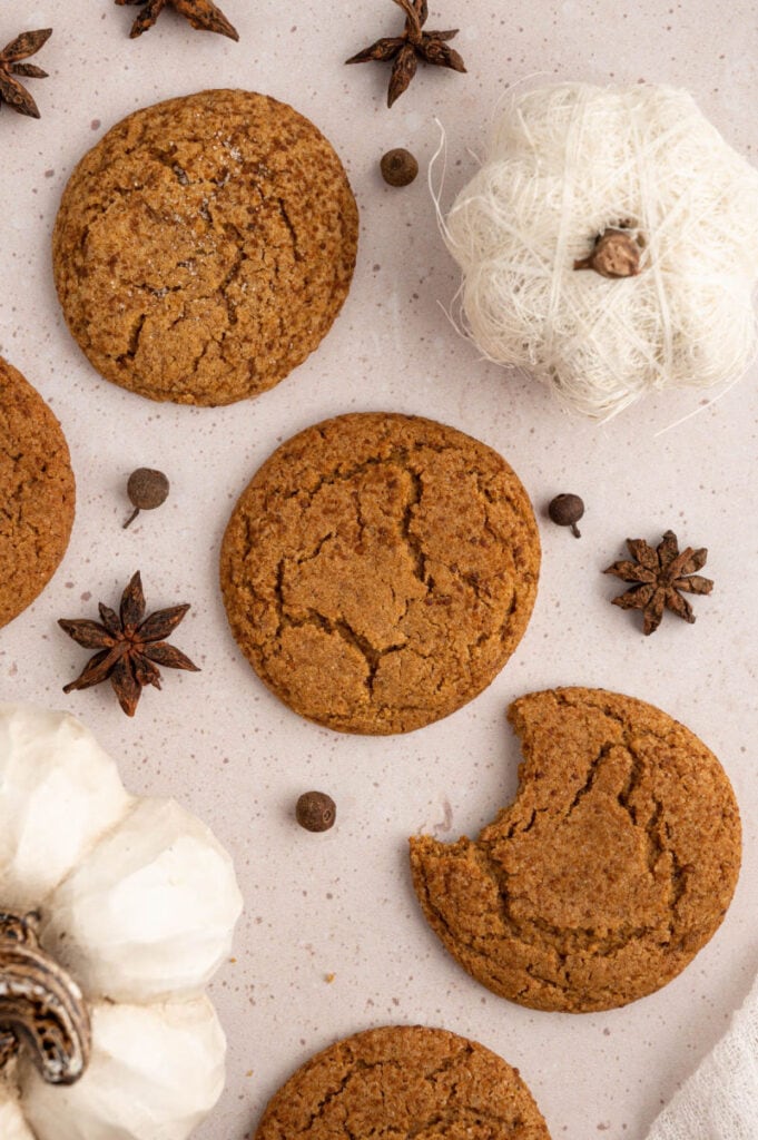 Gluten Free pumpkin cookies on a white background with one cookie with a bite taken out of it
