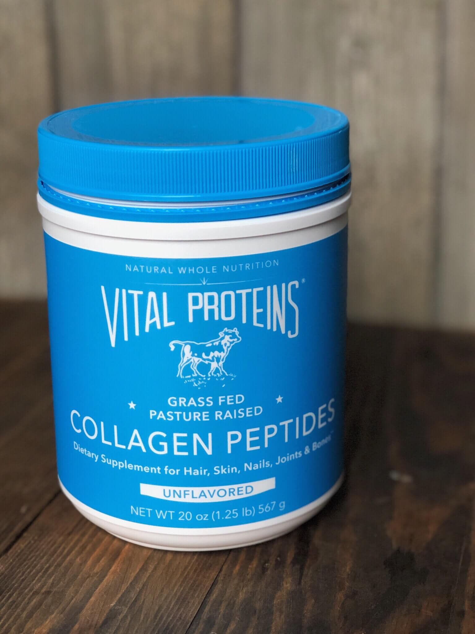 A canister of vital proteins collagen peptides on a wood background