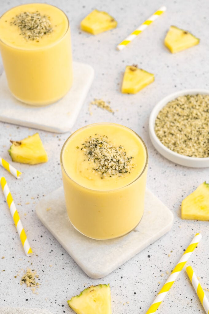Mango Pineapple smoothies with hemp seeds on top of them