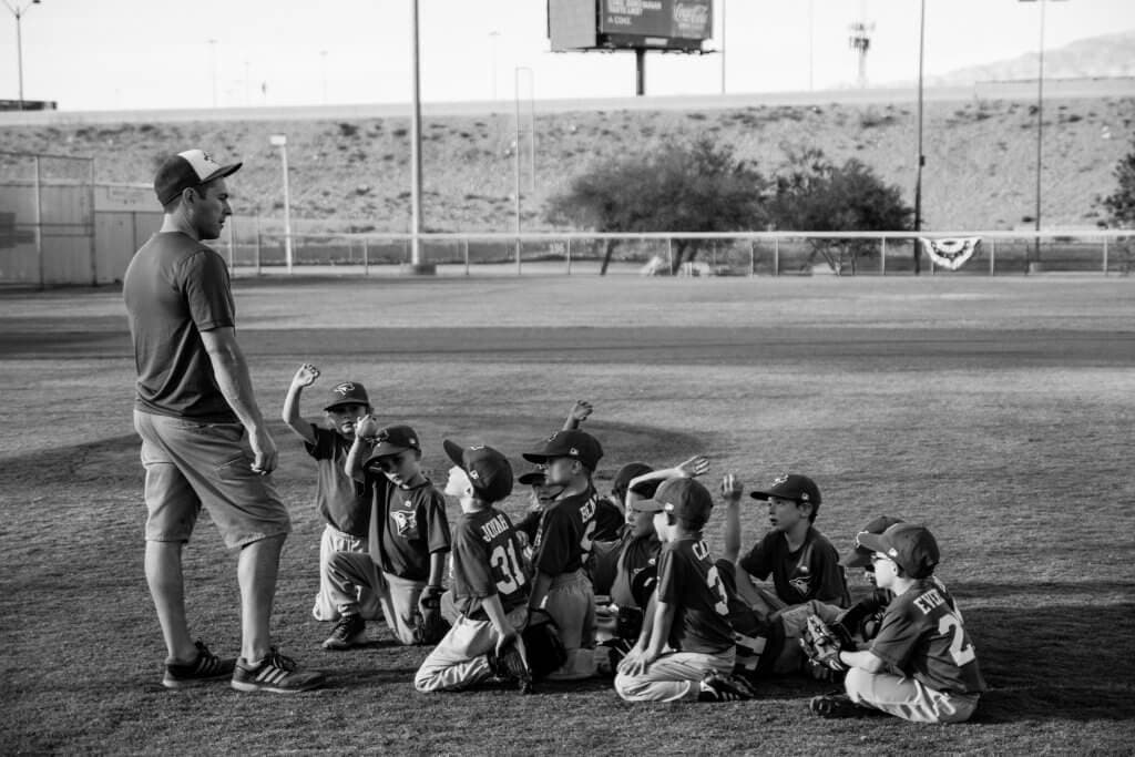 T-ball coach talking to young boys