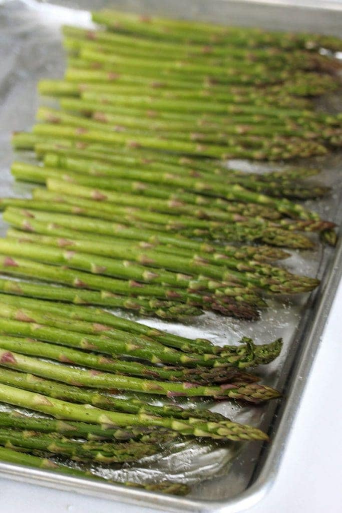 Asparagus lined on a baking rimmed sheet
