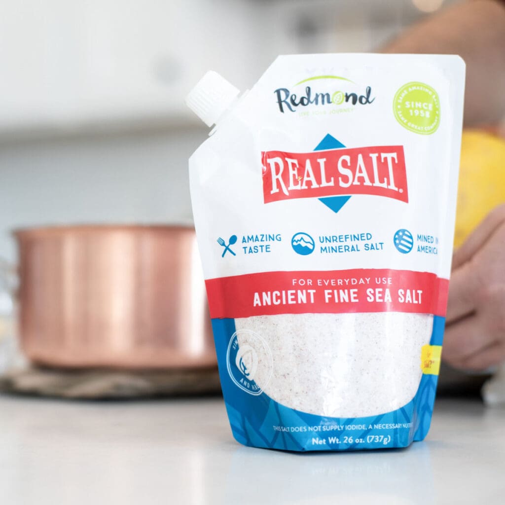 a package of Redmond Real Salt with a pan in the background