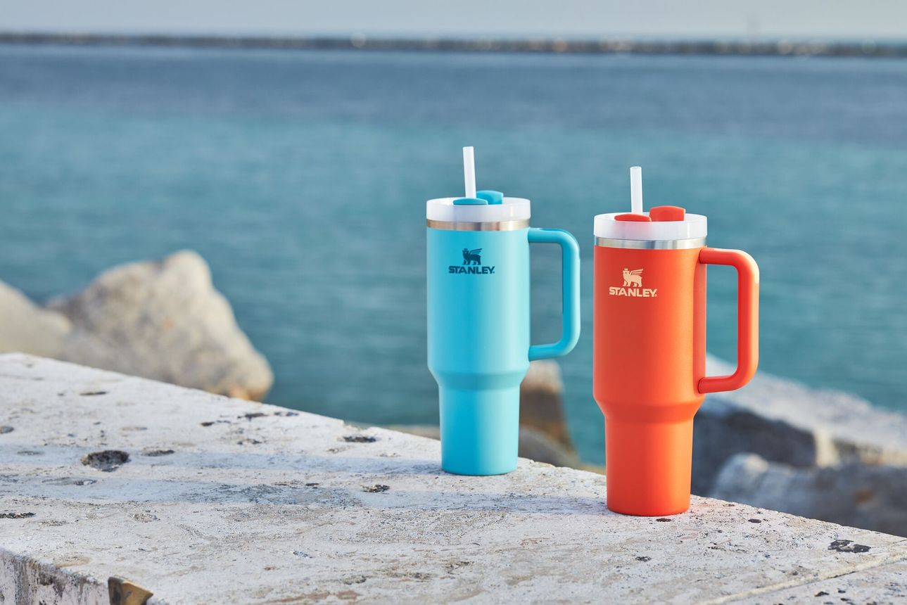 Two of Stanley's Quencher tumblers in blue and orange.