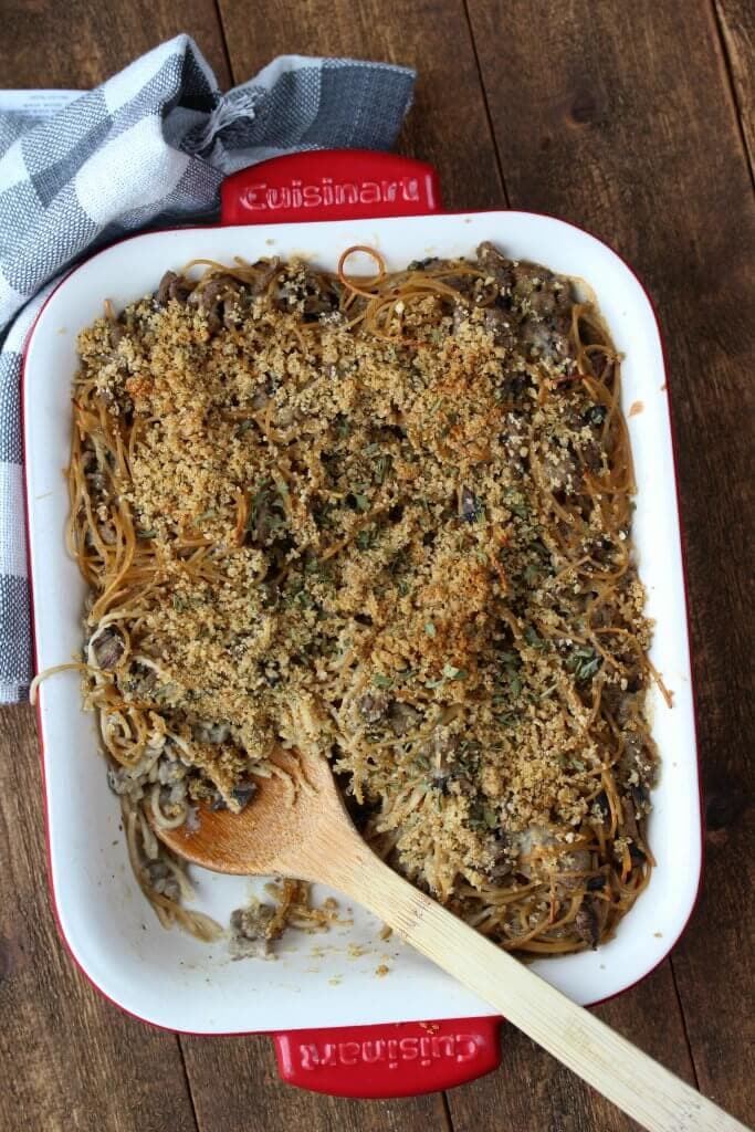 Overhead view of Turkey Tetrazzini Casserole with a spoon and serving missing.