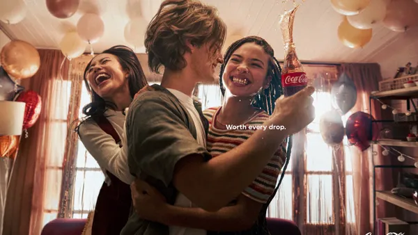 Three friends embrace in Coca-Cola's "Spill" campaign