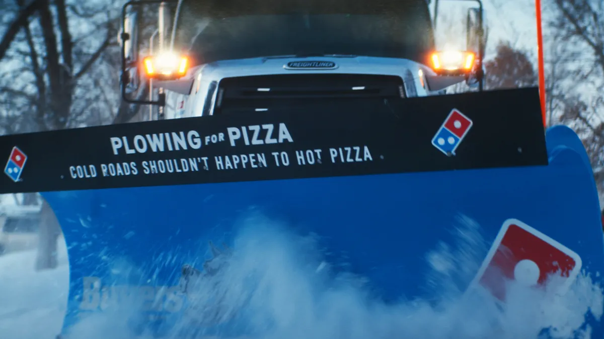 A Domino's branded plow in the snow