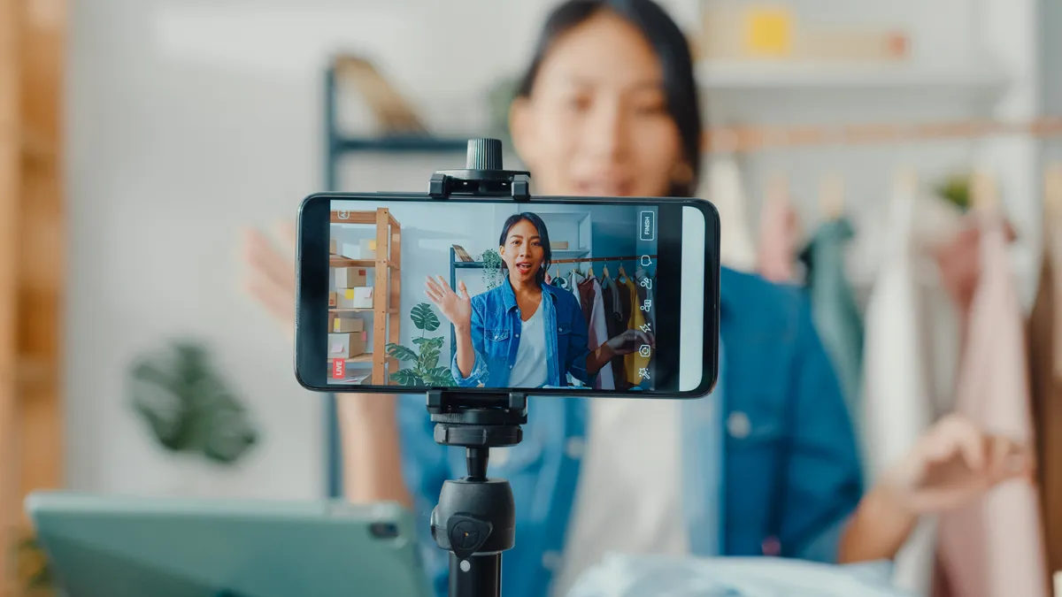 A person using their mobile phone to record a video of themselves.