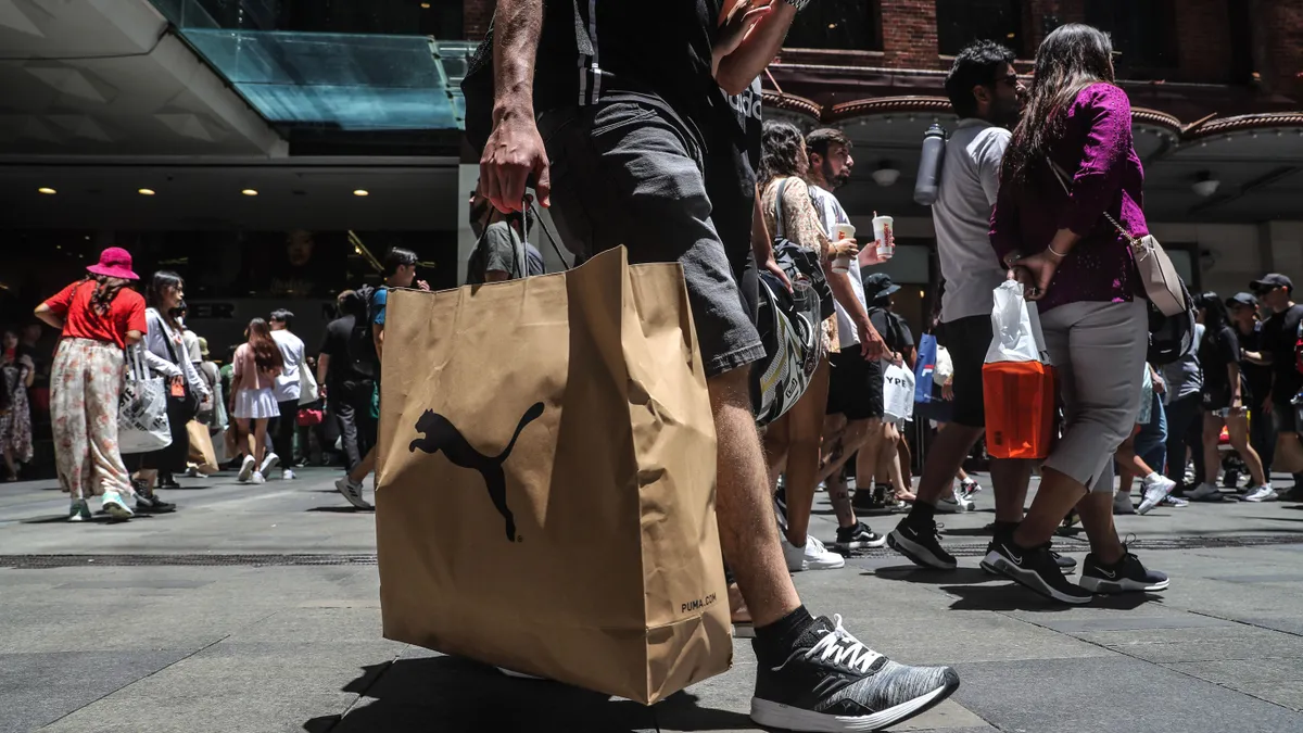 Shoppers pass by on a street in Sydney, Australia