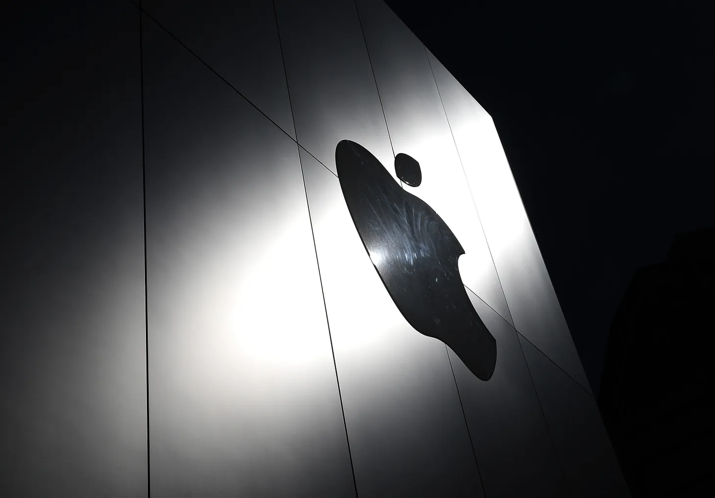 The Apple logo is displayed on the exterior of an Apple Store.