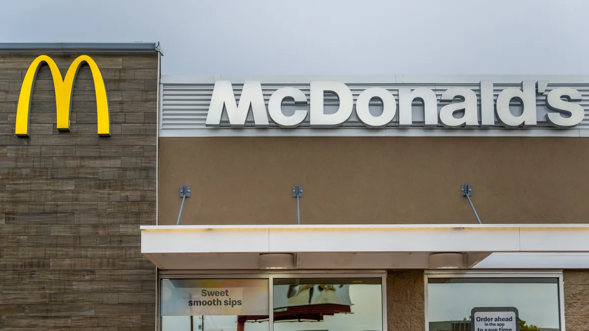 A beige building with a yellow "M" and white "McDonald's" sign.