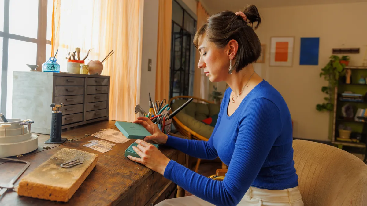 Person working on crafts in Etsy campaign spot