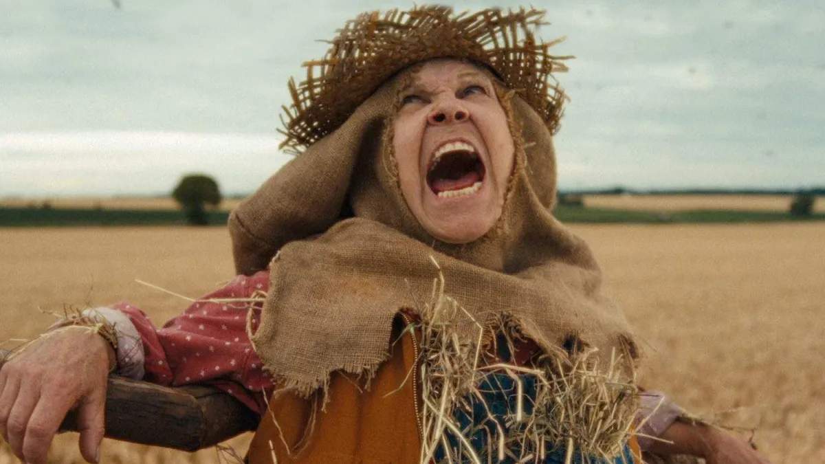 A woman poses as a scarecrow in a Kayak ad