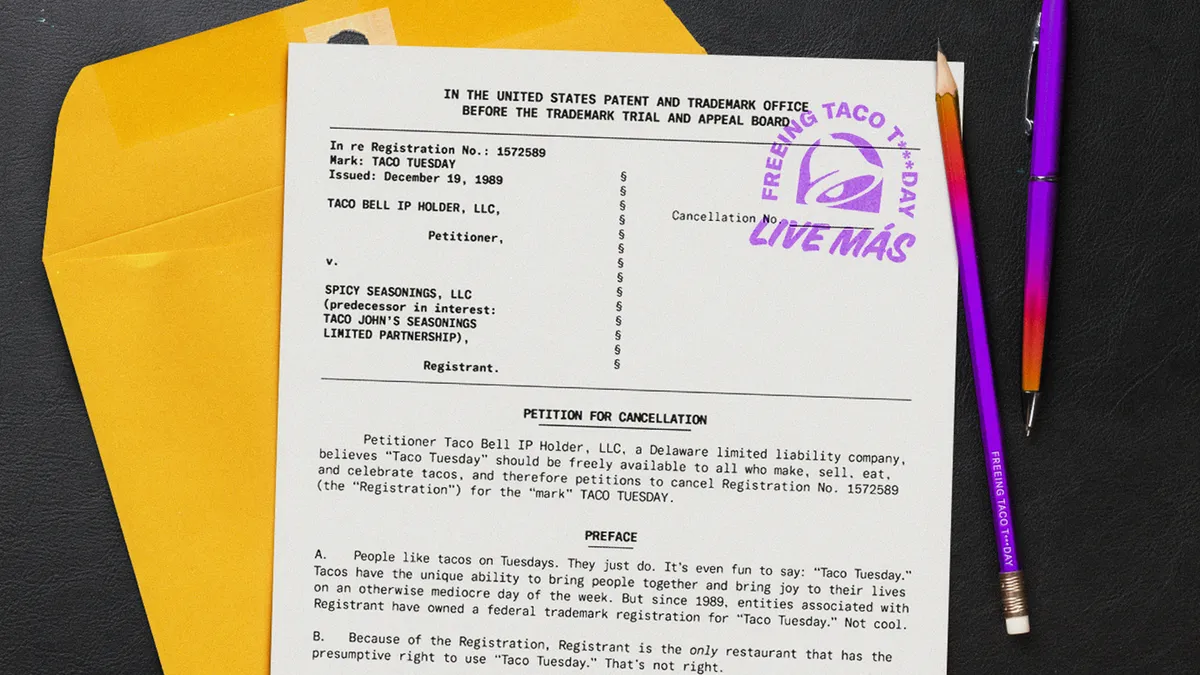 An envelope and document related to Taco Bell's petition to eliminate trademarks over Taco Tuesday sit on a desk next to a purple pencil and pen.