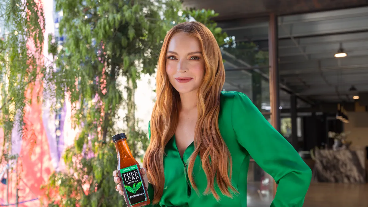 Lindsay Lohan poses with a bottle of Pure Leaf tea.