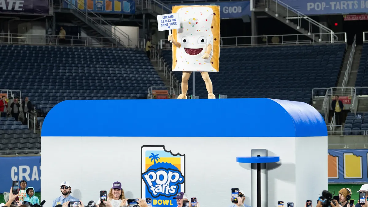 Pop-Tarts edible mascot stands atop a giant toaster at a college football game