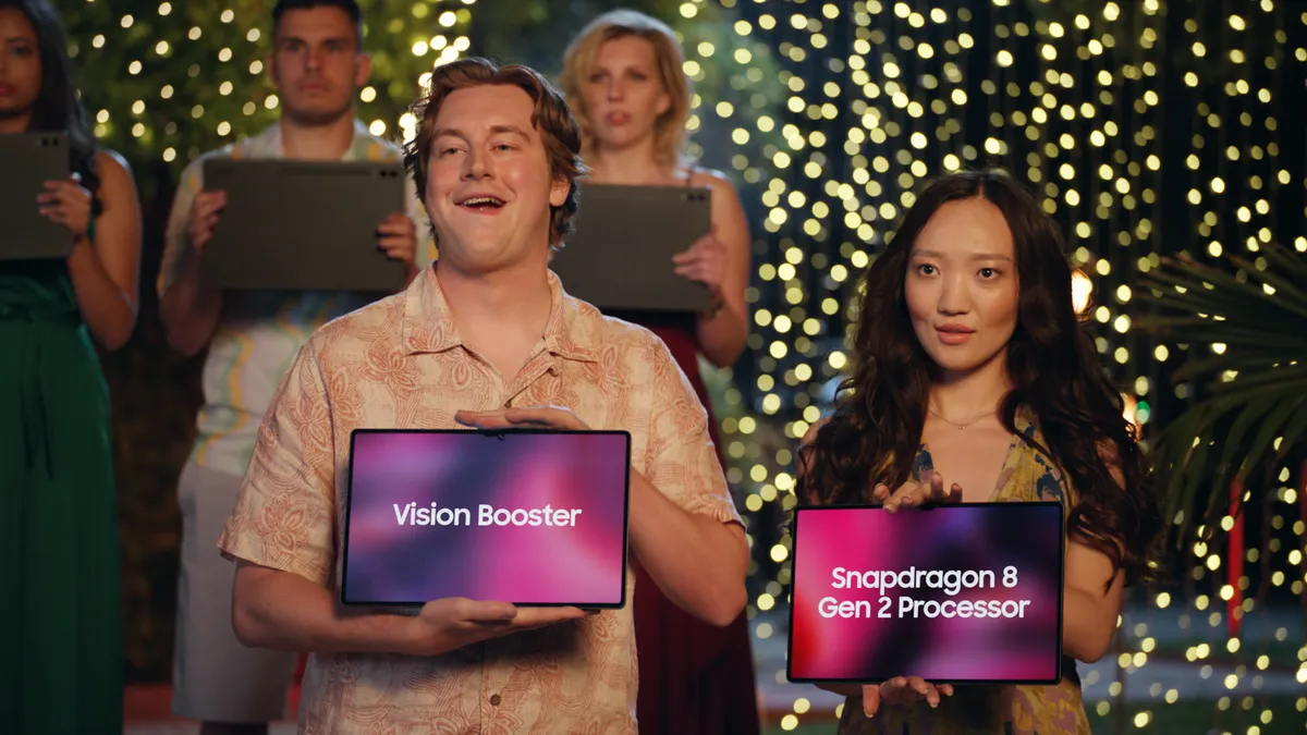 Two people hold Samsung Galaxy Tab S9 Series as part of a dating show parody in a new ad