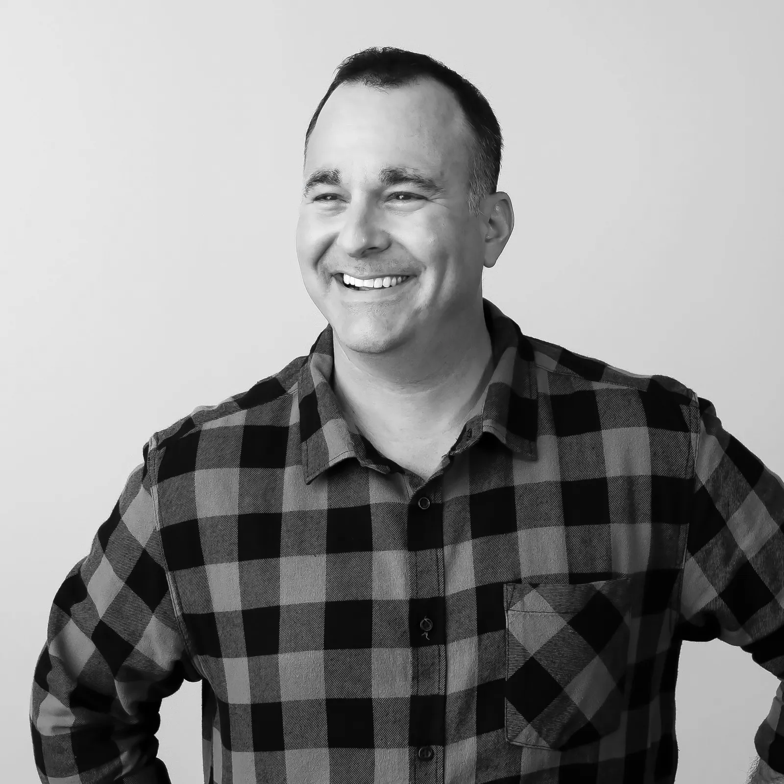 A black and white headshot of Kraft Heinz executive Todd Kaplan wearing a plaid shirt